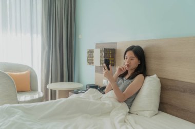 Asya kadın bir cep telefonu kullanarak, sorunları ve su hakkında düşünme