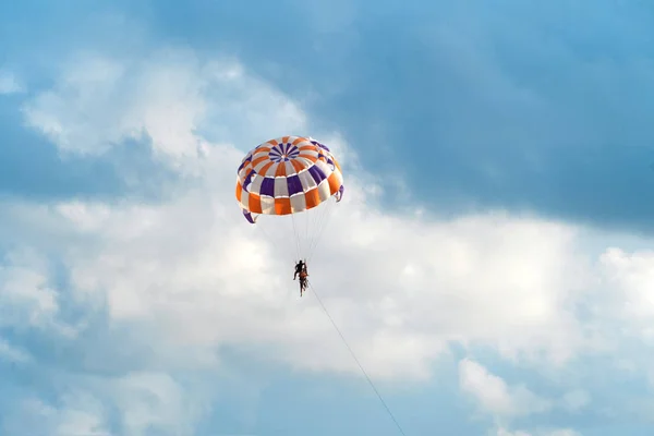 Människor som flyger i en färgglad fallskärm eller parasail tillsammans med — Stockfoto