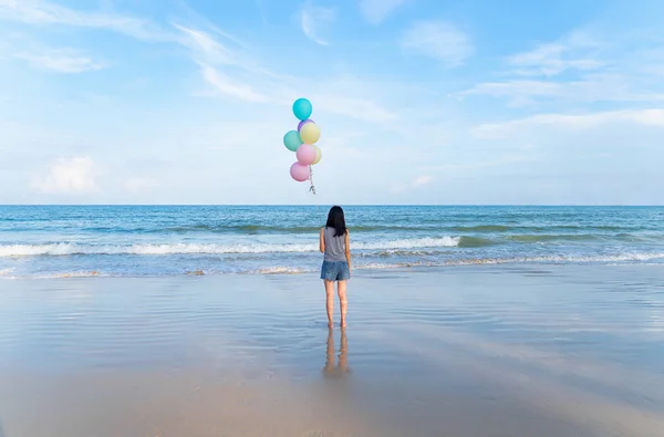 Mutlu Asyalı kadın sırasında plajda renkli balonlar tutan — Stok fotoğraf
