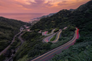 Eğimli, Zigzag yol veya sokakta sürüş araçların havadan görünümü 
