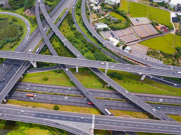 Aerial view of cars driving on highway junctions. Bridge roads w — Stock Photo, Image