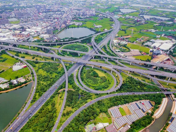 Aerial view of cars driving on highway junctions. Bridge roads w — Stock Photo, Image