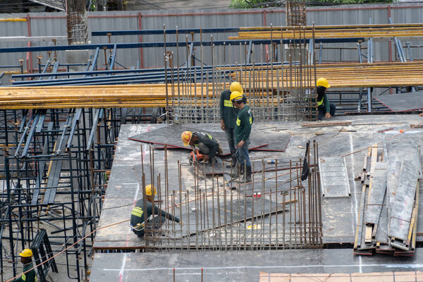 Aerial view of busy industrial construction site workers with cr