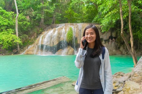 Mulher asiática feliz usando smartphone móvel para conversar ou chamar amigo — Fotografia de Stock