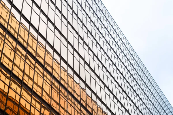 Golden building. Windows glass of modern office skyscrapers in t