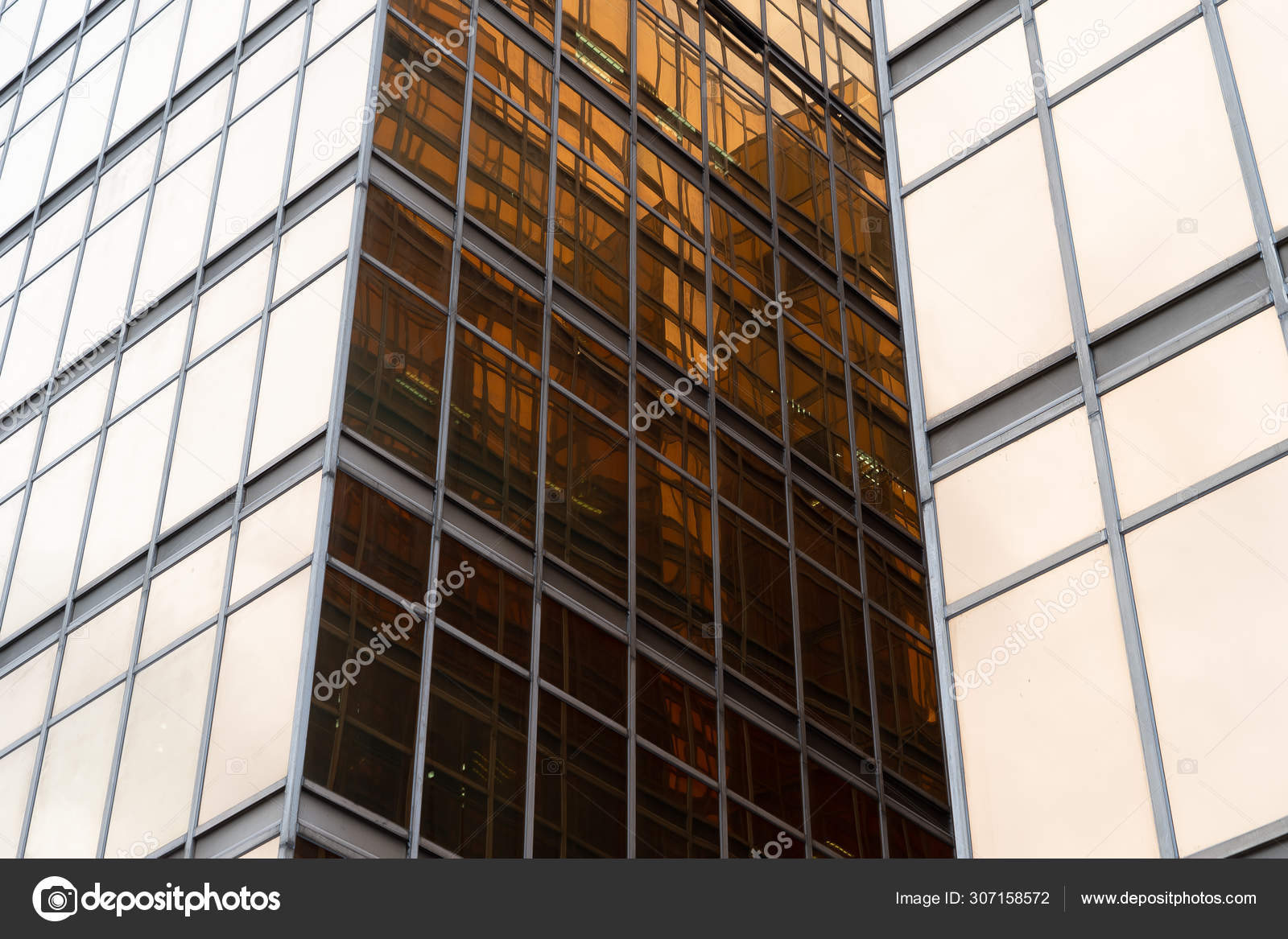 Golden building. Windows glass of modern office skyscrapers in t Stock  Photo by ©tampatra@ 307158572