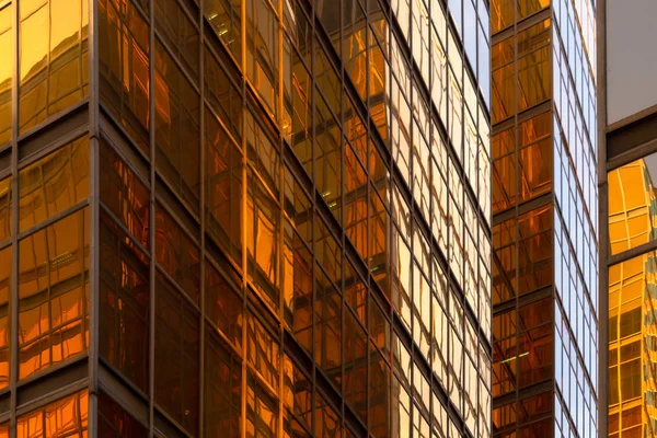 Złoty budynek. Szkło okna nowoczesnych wieżowców biurowych w t — Zdjęcie stockowe