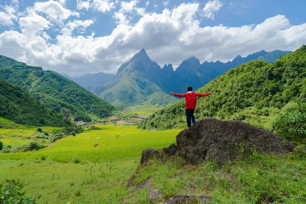 An Asian tourist man watching at Fansipan mountain hills with pa