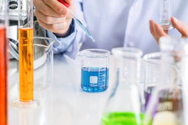 Laboratuvarda ya da laboratuarda teknoloji, kimya, sağlık, araştırma konsepti laboratuvarında covid-19 virüsünün aşısını analiz etmek ve geliştirmek için renkli test tüpleri üzerinde çalışan bilim adamları. Deneysel bilim testi