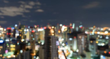 Bangkok, Tayland 'daki gökdelen binalarının soyut arkaplanı Bokeh, gece vakti bulanık fotoğraf. Şehir manzarası.