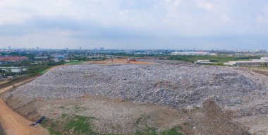 Çevre kirliliğinde endüstriyel fabrikada farklı tipteki dağ çöp yığını, plastik torbalar ve çöp yığınlarından oluşan hava manzarası. Çöp boşaltma alanında atık depolama.