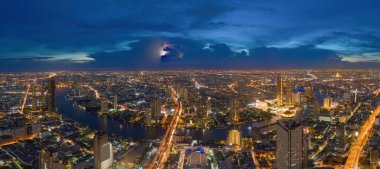 Chao Phraya nehri ile Bangkok şehir merkezinin gökyüzü manzarası. Tayland. Finansal bölge ve Asya 'nın akıllı kentsel kentindeki iş merkezleri. Geceleri gökdelen ve yüksek binalar