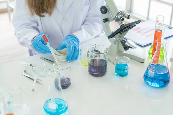 Scientist working on colorful test tube to analysis and develop vaccine of covid-19 virus in lab or laboratory in technology medical, chemistry, healthcare, research concept. Experimental science test
