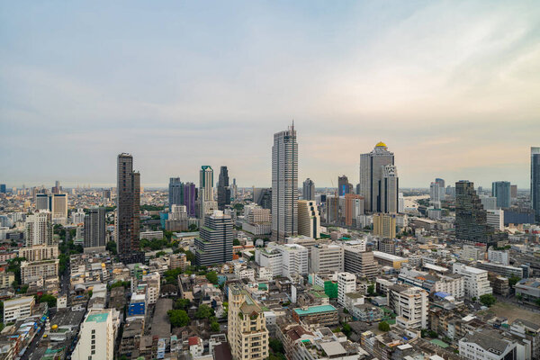 Aerial view of Bangkok Downtown Skyline with road street. Thailand. Financial district and business centers in smart urban city in Asia. Skyscraper and high-rise buildings at sunset.