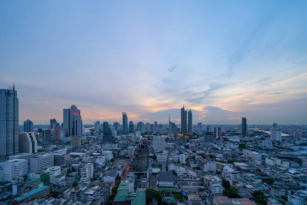 Aerial view of Bangkok Downtown Skyline with road street. Thailand. Financial district and business centers in smart urban city in Asia. Skyscraper and high-rise buildings at sunset.