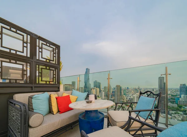 Sky bar, a restaurant or cafe lounge terrace with dinner table on rooftop of hotel, high rise architecture building with city view in Bangkok downtown skyline, urban city, Thailand.