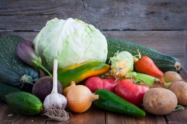 Ahşap bir masa üzerinde sonbahar sebze: lahana, Mısır, pancar, havuç, patates, soğan, sarımsak, domates, biber, seçici odak