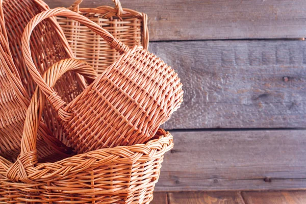 Woven empty baskets from natural handmade vines for mushrooms, handicrafts, storage, walks, picnic on a wooden table, copy space