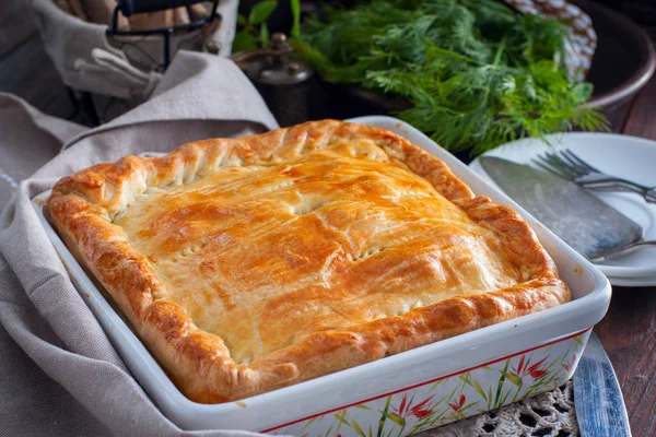 Chicken, potato and onion puff pastry cake, selective focus