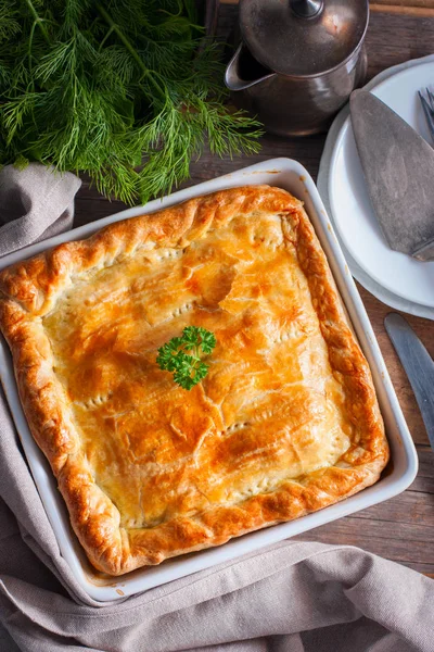 Puff pastry pie with chicken, potatoes and onions, quute pie, selective focus, top view