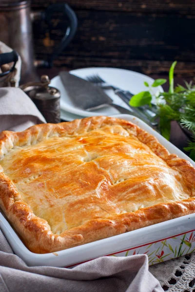 Chicken, potato and onion puff pastry cake, selective focus