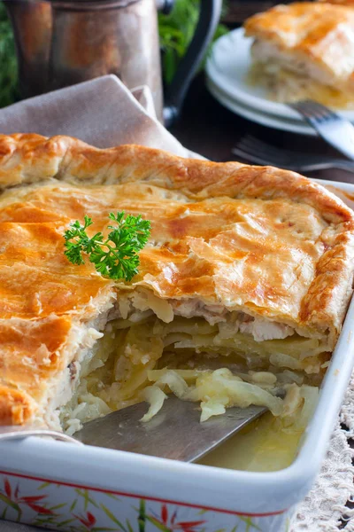 Puff pastry pie with chicken, potatoes and onions, qubit pie, selective focus