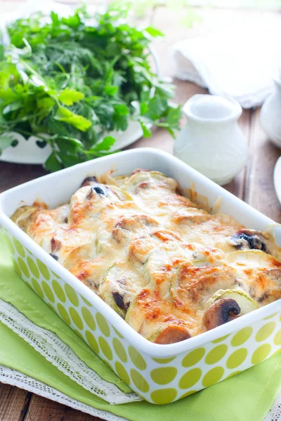 Zucchini baked with champignons with sour cream and cheese, selective focus — Stock Photo, Image