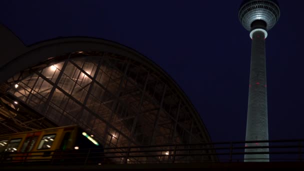 由德国柏林电视塔在夜间乘火车离开亚历山大广场站 — 图库视频影像
