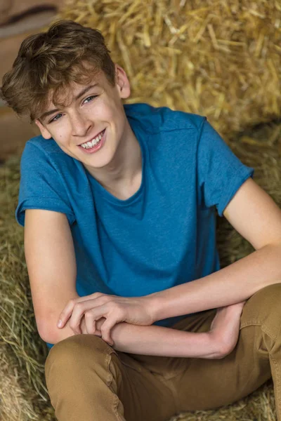 Молодой Человек Счастливо Улыбается Смеющийся Мальчик Подросток Сидящий Тюках Сена — стоковое фото