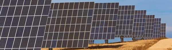 Panoramic web banner of photovoltaic solar panels providing alternative green energy