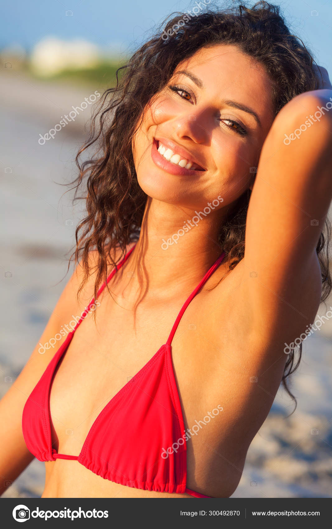 Young woman in red bikini on beach - Stock Image - F009/2861 - Science  Photo Library