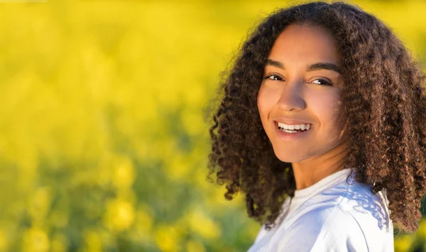 Happy Mixed Race Biracial African American Teenager Woman in Yellow Flowers — Stock Photo, Image