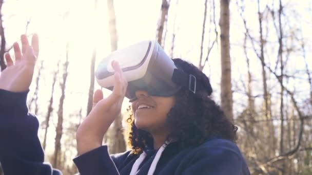 森林の森の環境でバーチャルリアリティVrヘッドセットを使用して美しい混合レースアフリカ系アメリカ人の女の子の女の子の若い女性のビデオクリップ — ストック動画