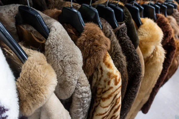 Rail of Secondhand Fur Coats for Sale in a Thrift Store Shop — стоковое фото