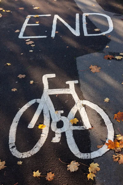 End of bicycle or cycle lane sign painted on a path or pavement