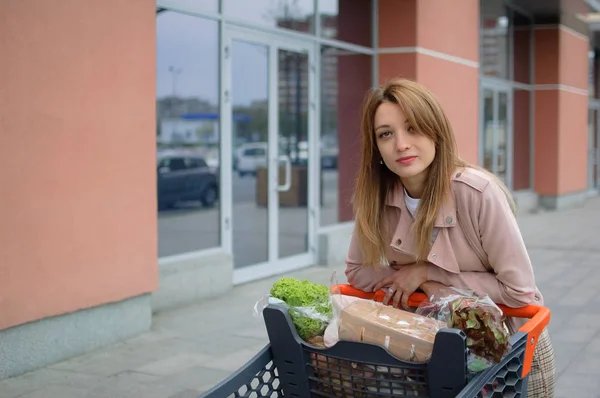 Hermosa chica en el tranvía cerca del supermercado. Exterior —  Fotos de Stock