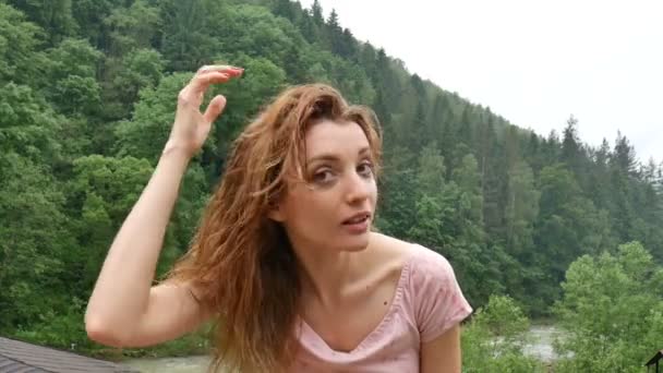 Happy curly girl in the mountains enjoys summer rain without an umbrella. The girl is happy and laughs cheerfully. beauty of nature — Stock Video