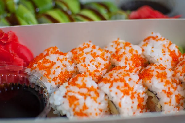 California sushi rolls set in carton box close up. Food for take away or sushi delivery concept