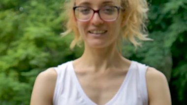 At kuyruğu ile Genç güzel kız yeşil ağaç arka plan üzerinde yağmurlu havalarda açık havada yararlı bir bambu diş fırçaları tutuyor. Çevre dostu ve sıfır atık kavramı.