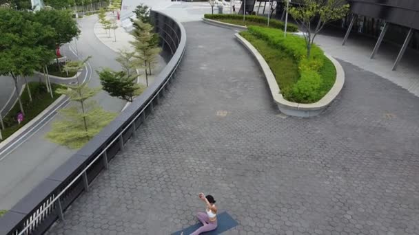 Aerial Drone View Asian Chinese Female Woman Practising Street Yoga — Stock Video