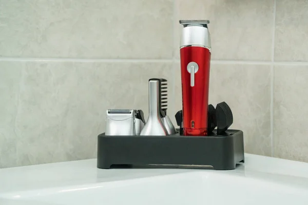 Beard trimmer with attachment in a bathroom closeup