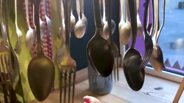 A little boy is played with decorative tableware. Baby boy plays with spoons — Stock Video