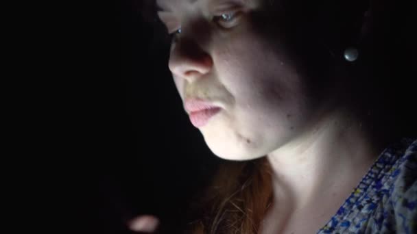 Happy girl smiles and kisses phone in the dark. Girl learned the good news — Stock Video