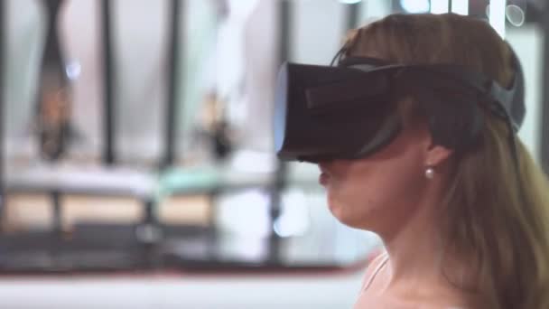 Chica joven con gafas de realidad virtual expresa sorpresa y dice "Wow " — Vídeo de stock