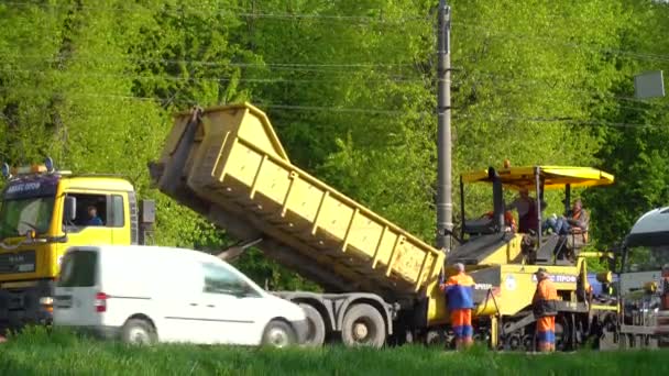 Ternopil, Ucrania, mayo de 2020: Los trabajadores de la carretera están reparando la carretera mientras que el tráfico por carretera con el uso de equipos de carretera. Trabajos de carretera — Vídeos de Stock