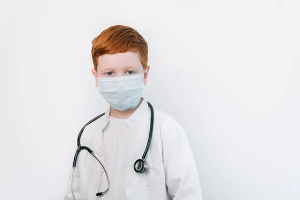 Close up of caucasian littile doctor with a stethoscope in protective mask — Stock Photo, Image