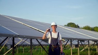 Adam iyi çalışıyor mu diye güneş pilini kontrol ediyor. Yeşil enerji kavramı