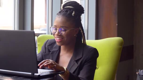Gelukkige Afro-Amerikaanse jonge vrouw die communiceert via conference call spreken op zoek in laptop. Video chat job interview of afstand taal cursus klasse concept — Stockvideo