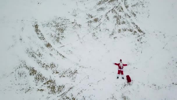 Babbo Natale è sdraiato sulla spiaggia innevata. Vista dall'alto. Babbo Natale nell'Artico — Video Stock