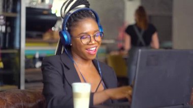 Mutlu Afrikalı Amerikalı genç kız barda müzik dinliyor.